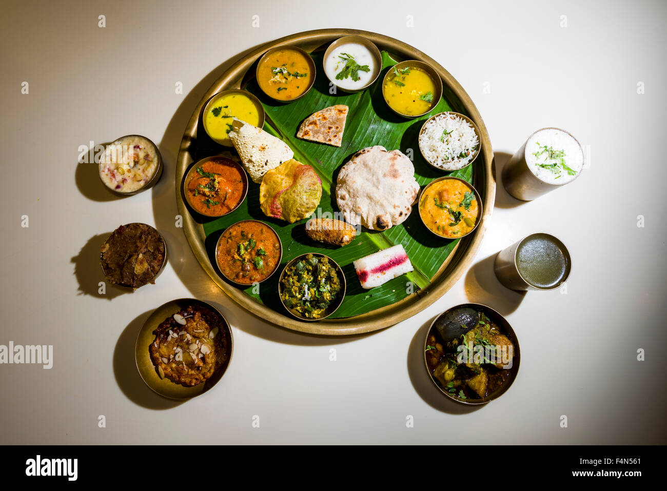 The traditional dish Thali usually consists of some different vegetable or non vegetable dishes, rice, curd, bread, papadam and Stock Photo