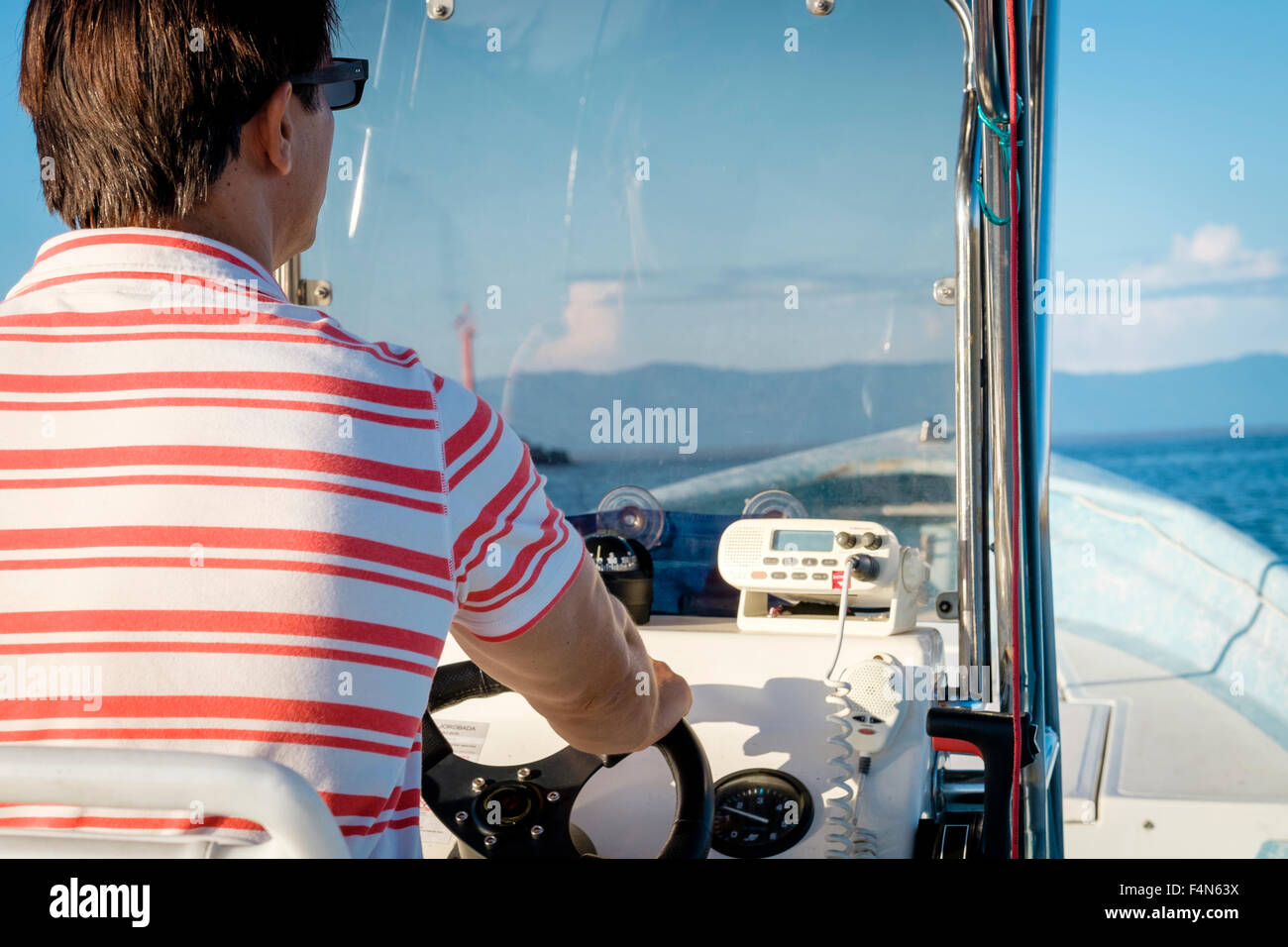 Mature man steering sea hi-res stock photography and images - Alamy
