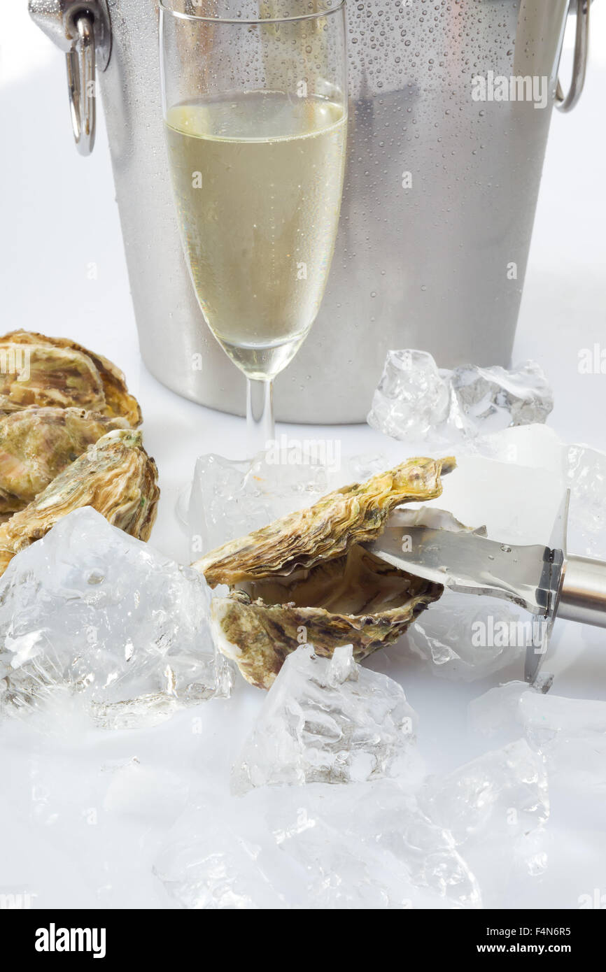 Oyster and knife, ice, champagne glass Stock Photo Alamy