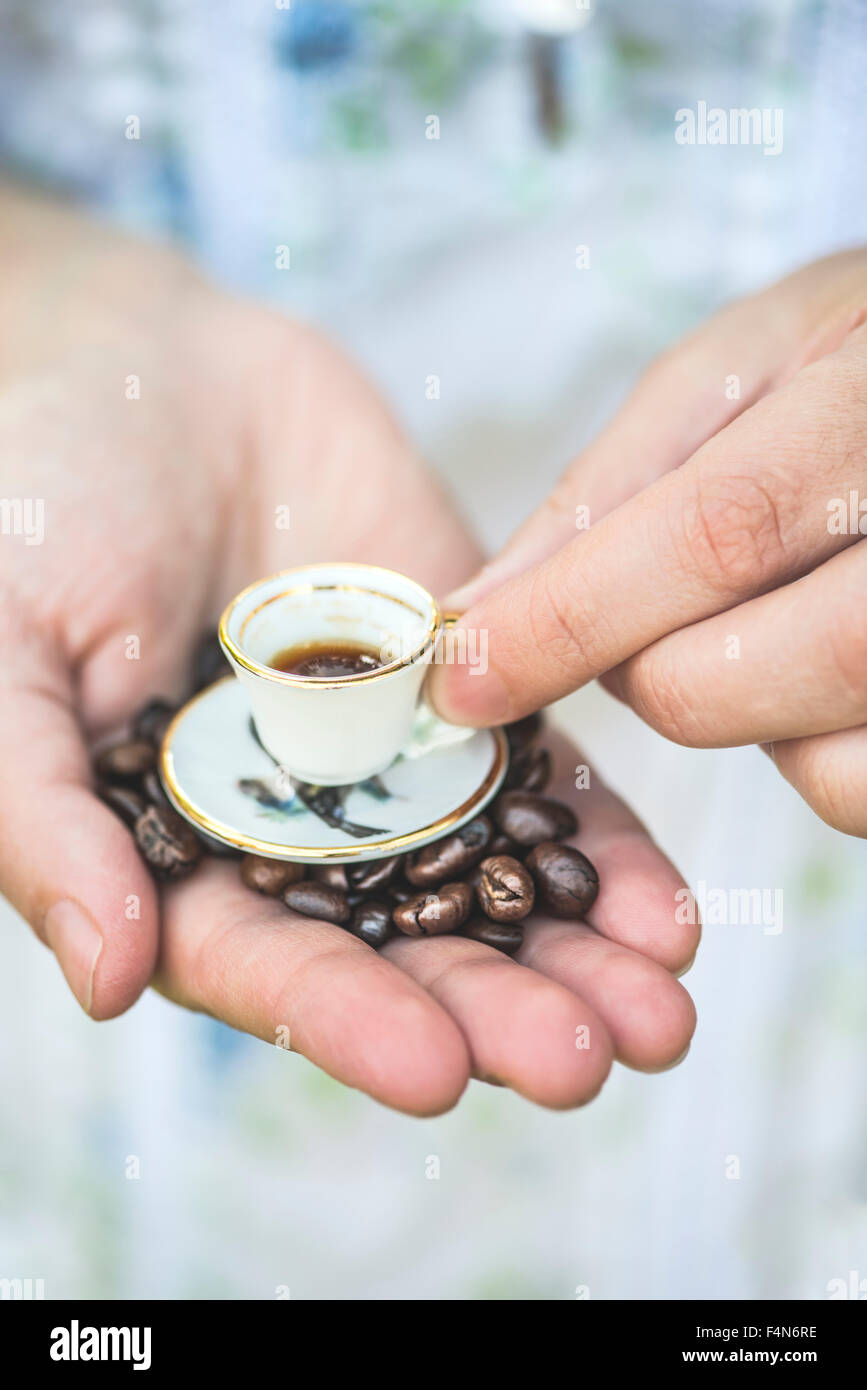 hand-hold-very-small-cup-of-coffee-F4N6RE.jpg