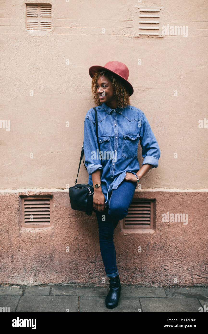 Woman wearing denim shirt leaning hi res stock photography and