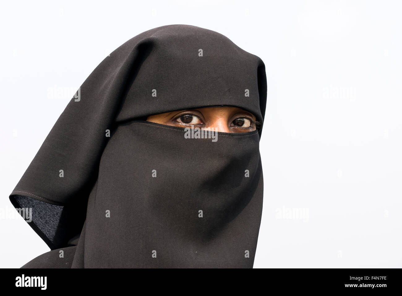 A portrait of a muslim woman dressed in the traditional black burka including the hijab Stock Photo