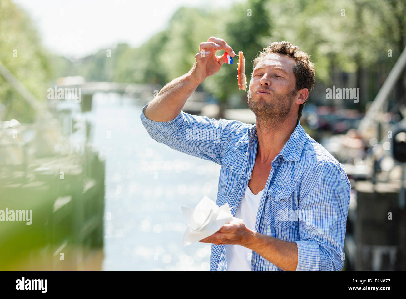 Netherlands, Amsterdam, man eating matjes herring Stock Photo Alamy