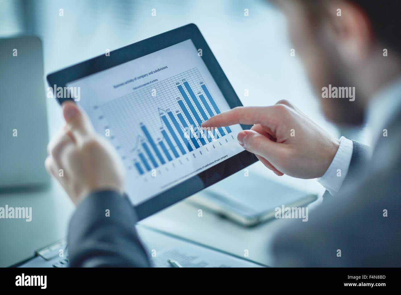 Human hand pointing at financial chart in digital tablet Stock Photo ...