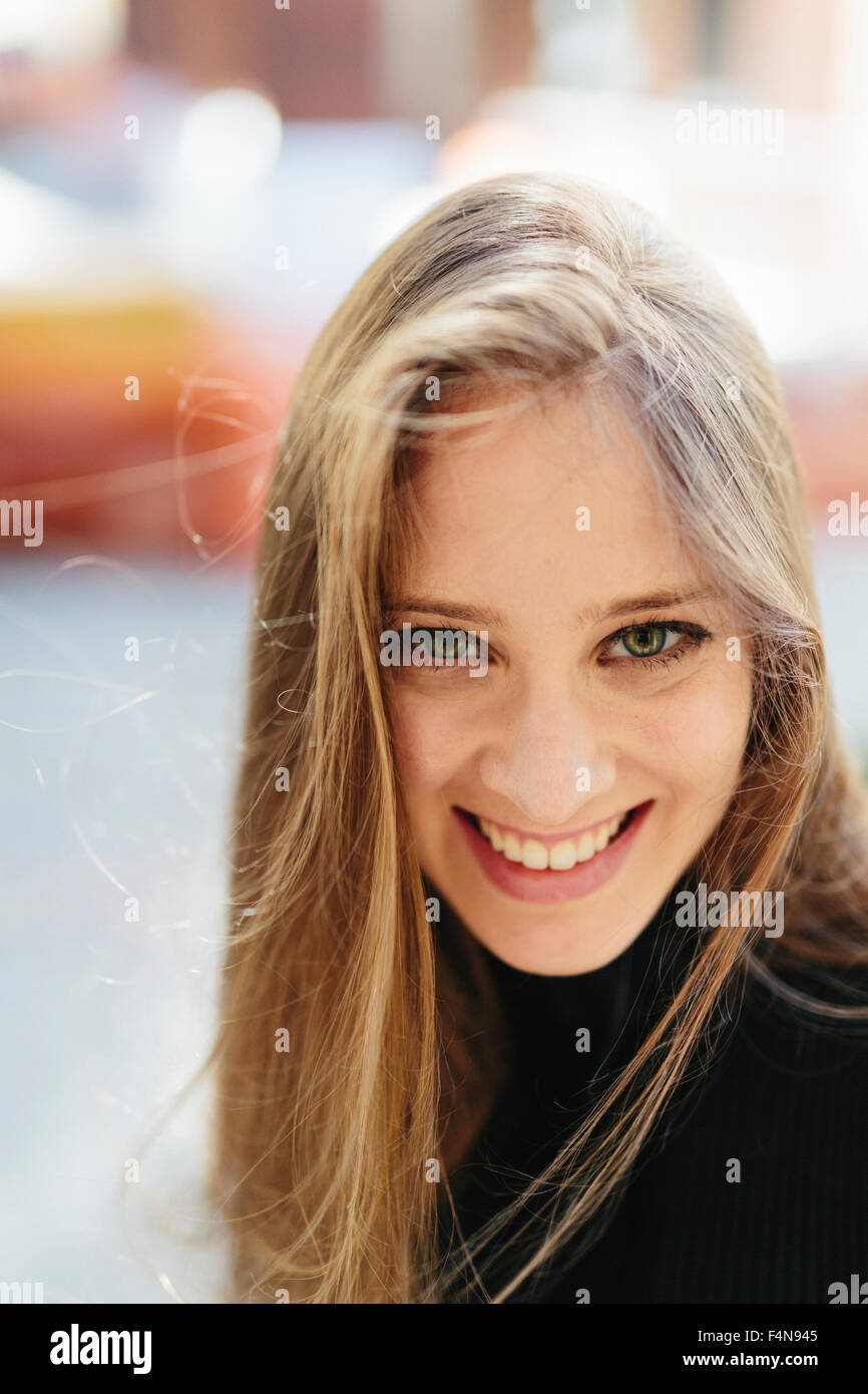 Portrait of smiling young woman Stock Photo - Alamy