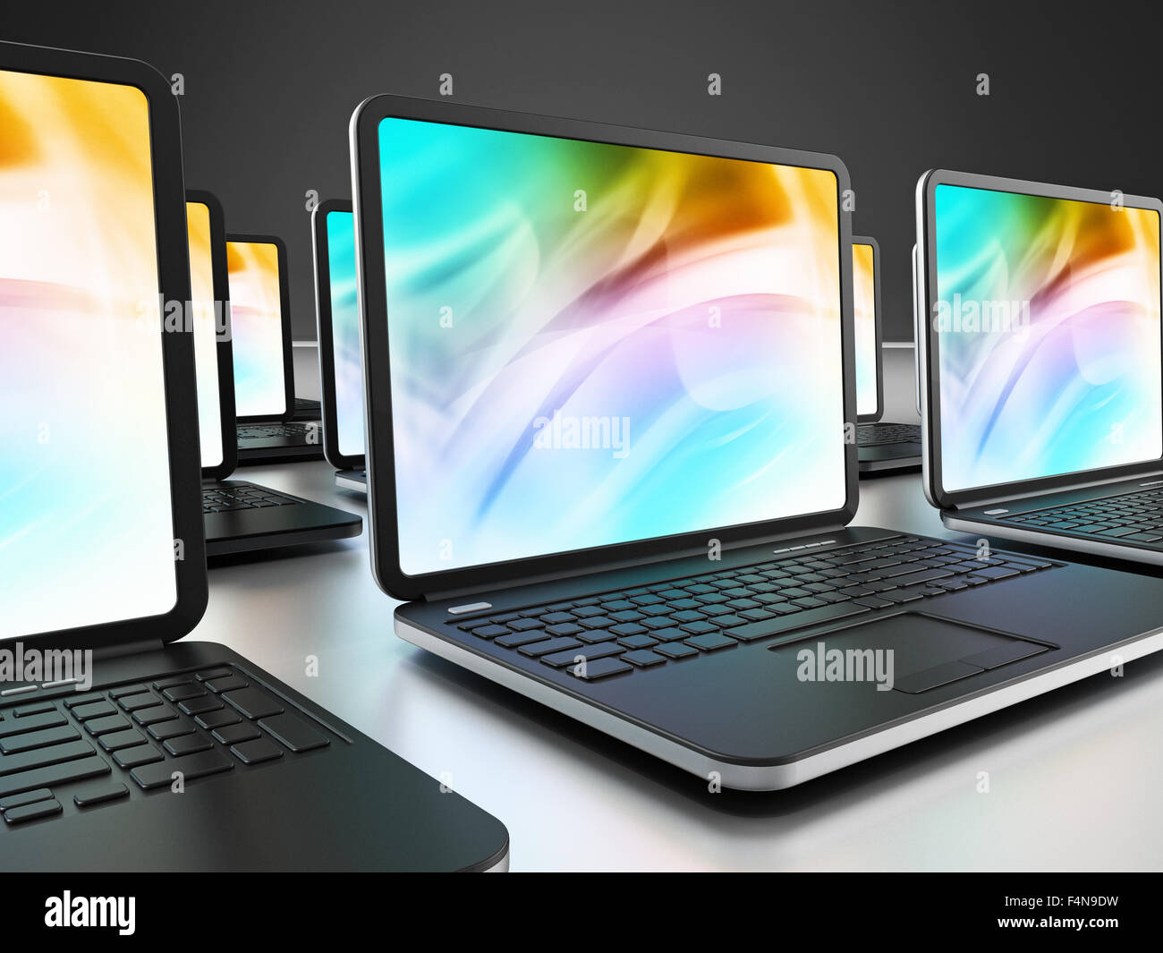 Laptop computers standing in a row Stock Photo