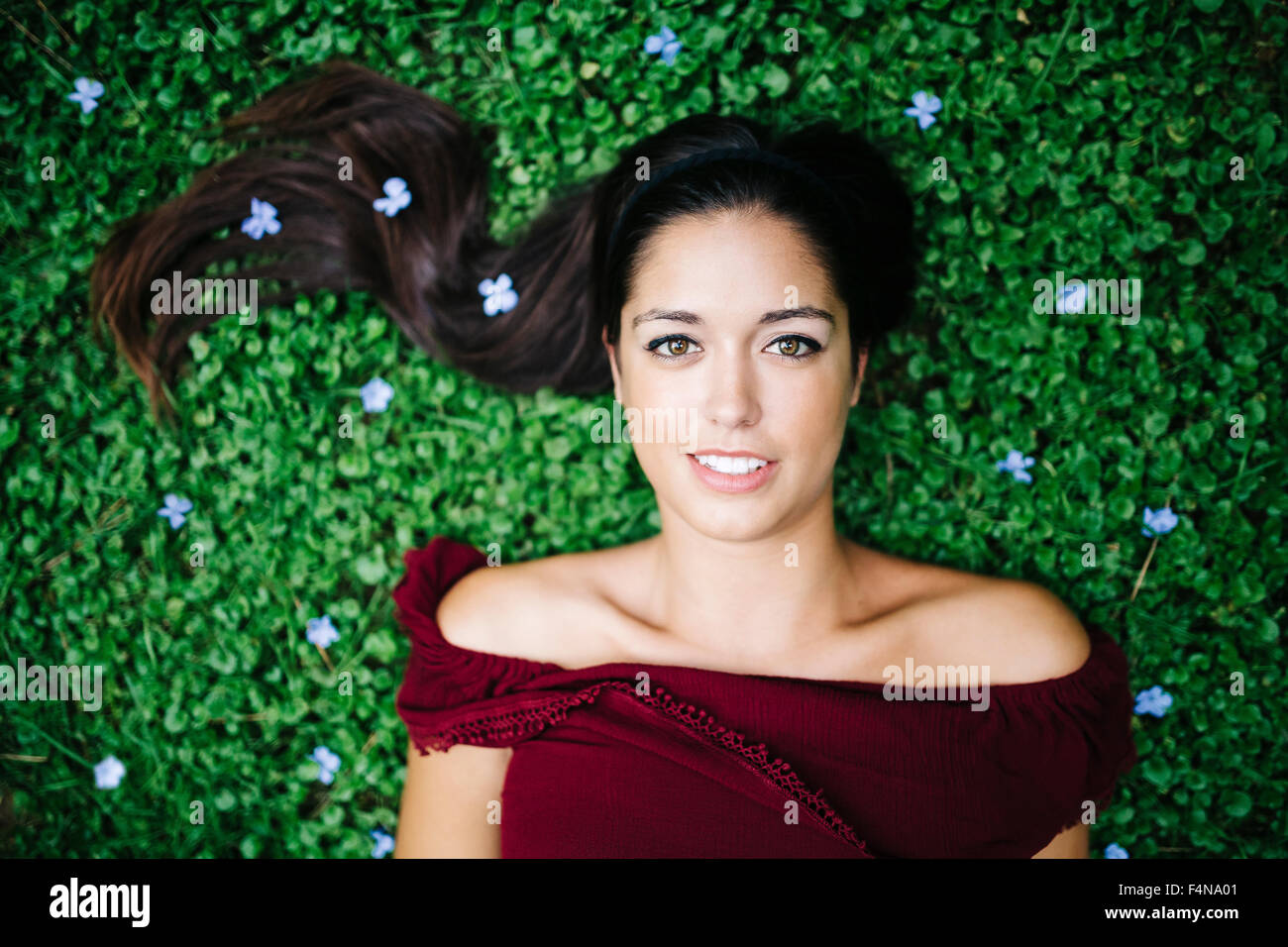 Portrait young woman lying on a meadow Stock Photo - Alamy