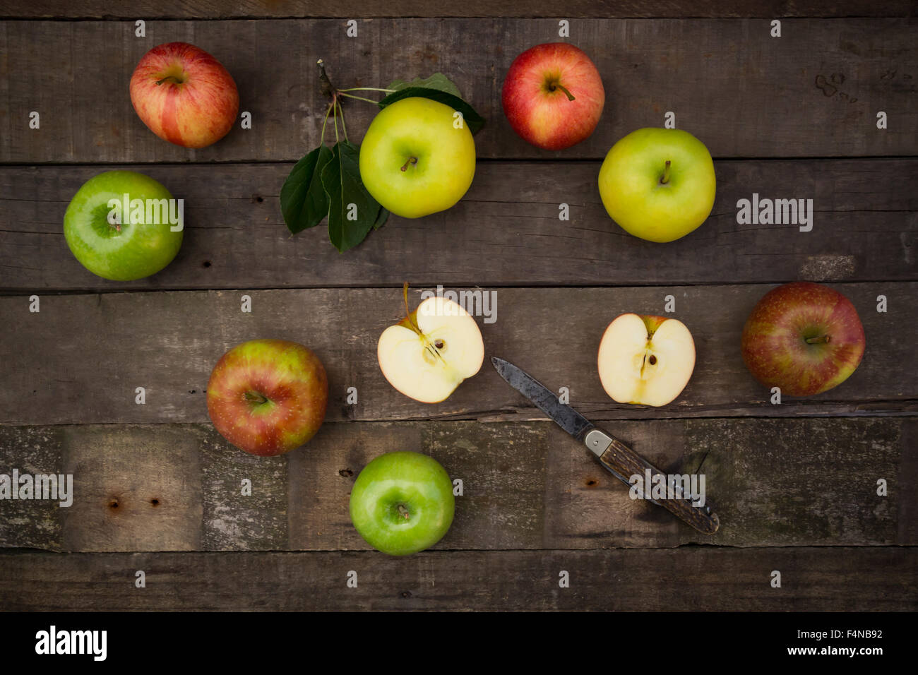 Different apples and pocket knife on wood Stock Photo Alamy