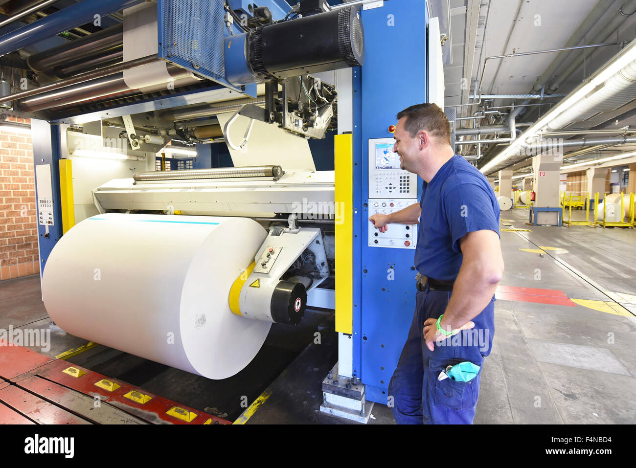 Man operating printing machine in a printing shop Stock Photo Alamy