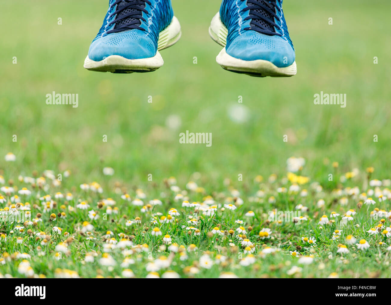 Jumping feet in trainers, midair Stock Photo Alamy