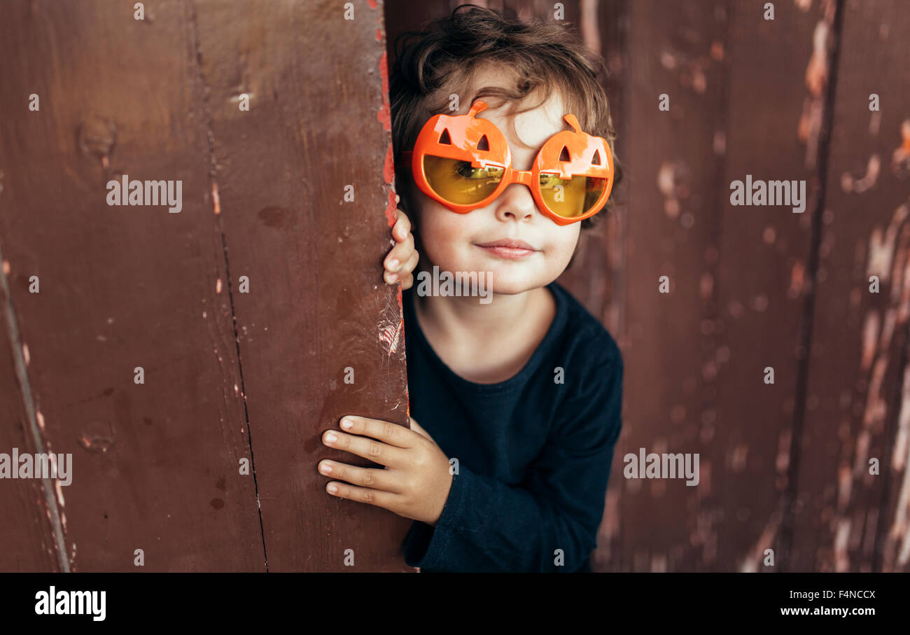 Portrait of little girl wearing halloween glasses shaped like pumpkins Stock Photo