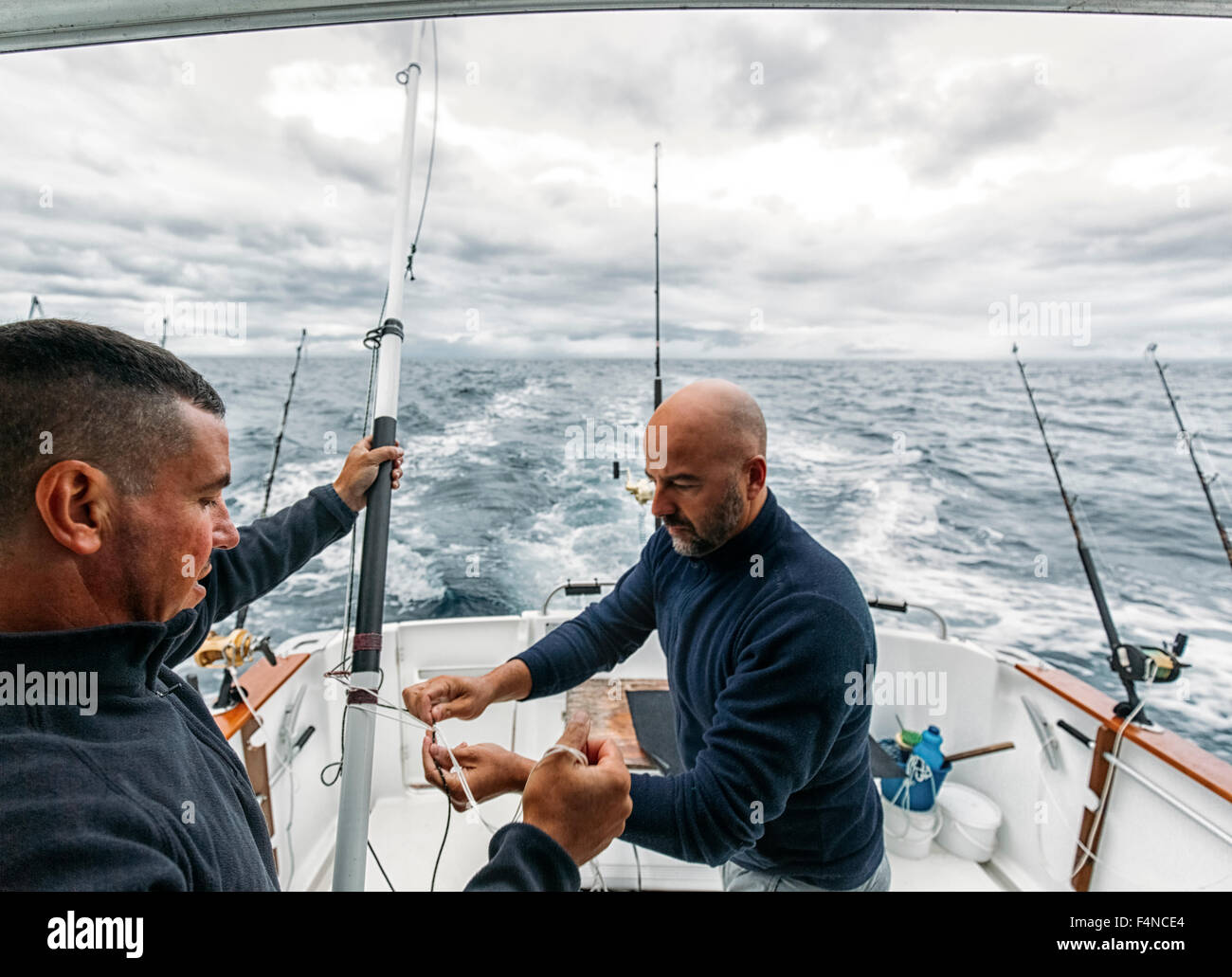 Spain, Asturias, Fishermen on fishing boat on Cantabrian Sea Stock Photo