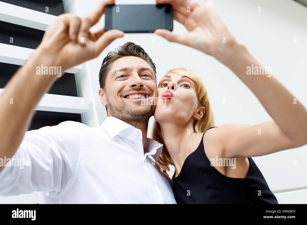 Couple taking a selfie with smartphone Stock Photo - Alamy