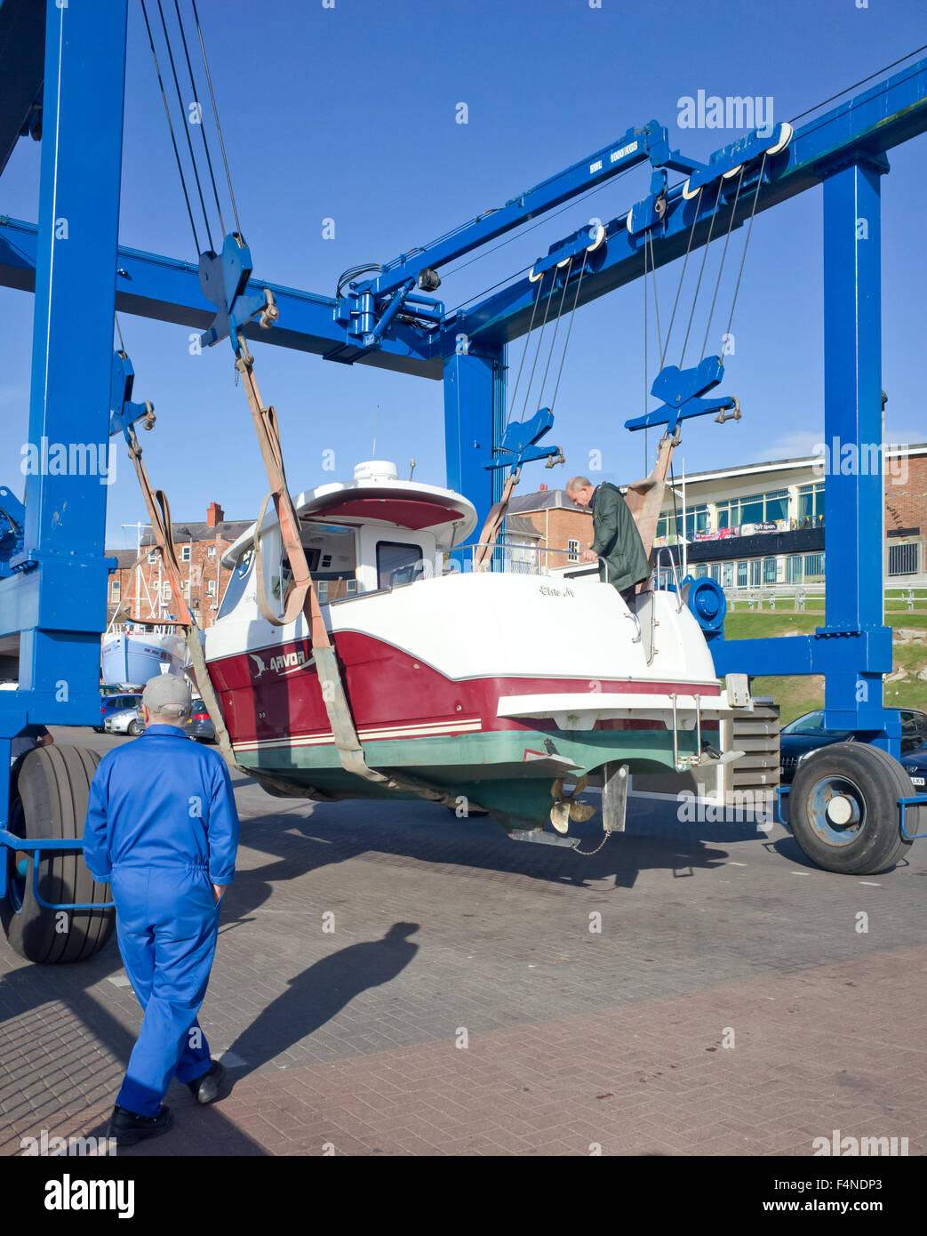 Small Pleasure boat Slung under hoist prior to launching, Bridlington