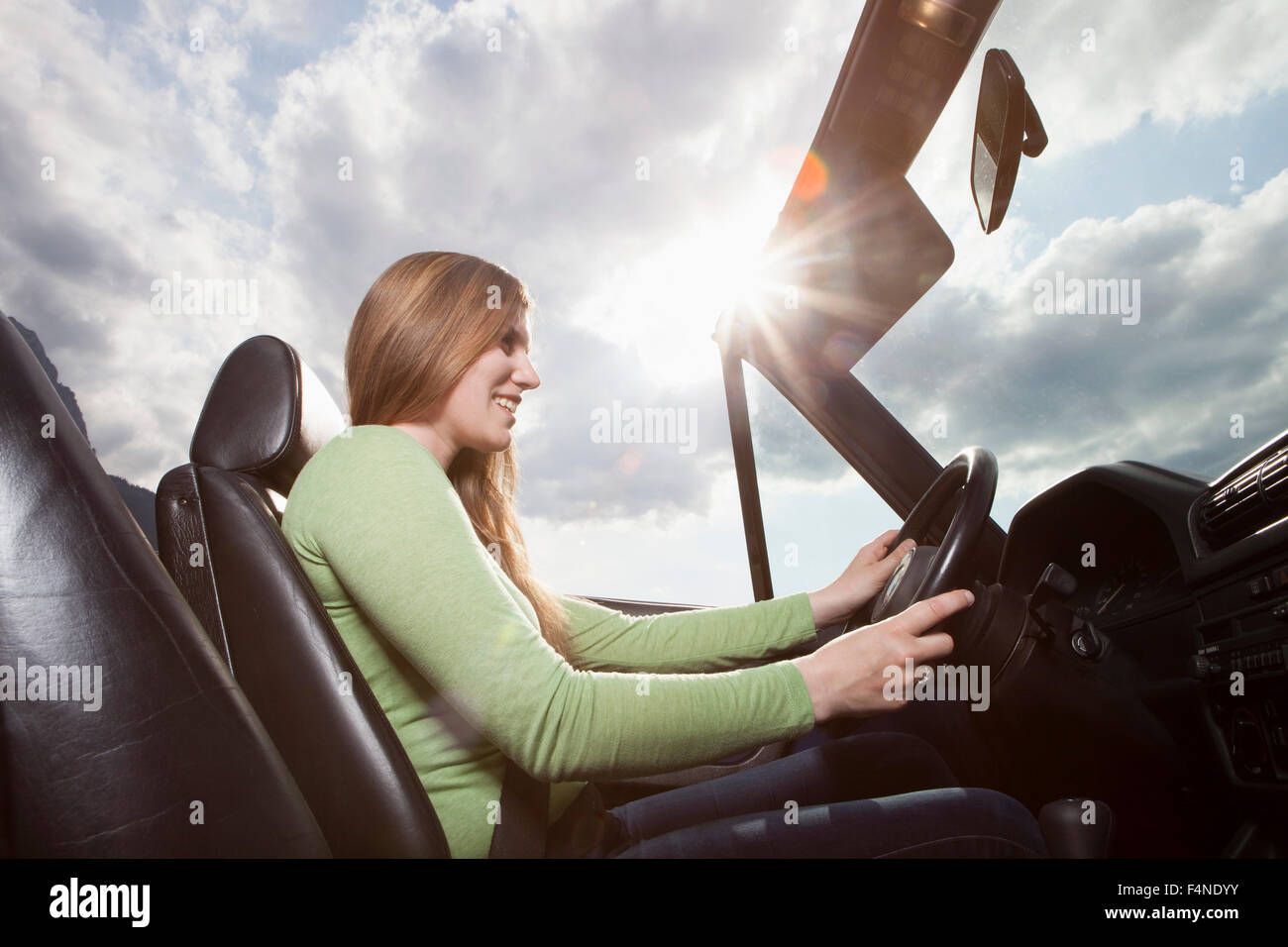 Germany, Bavaria, happy woman in a convertible Stock Photo