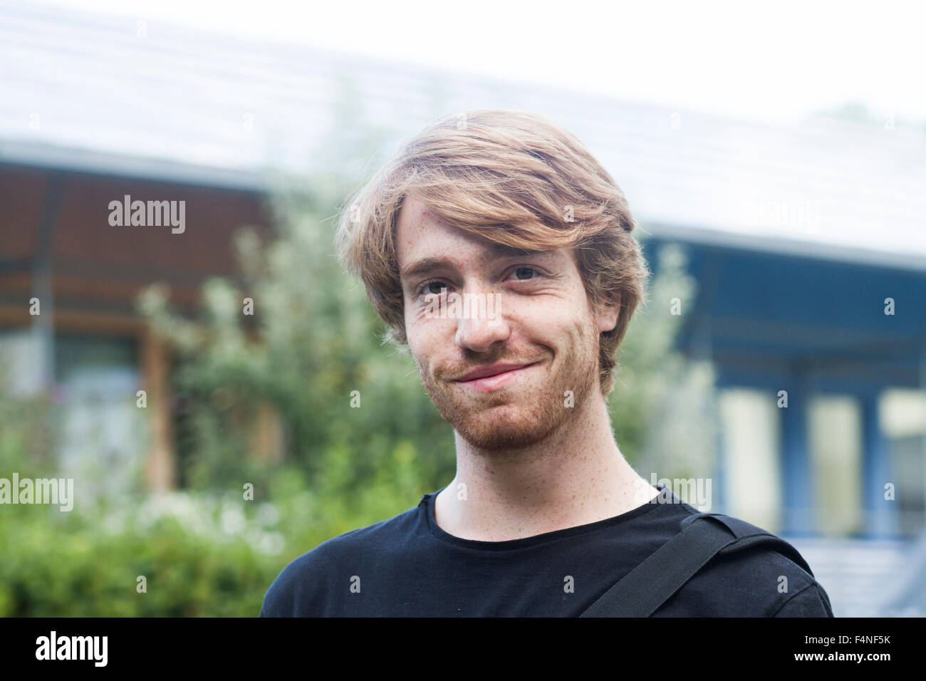 Portrait of smiling young man Stock Photo - Alamy