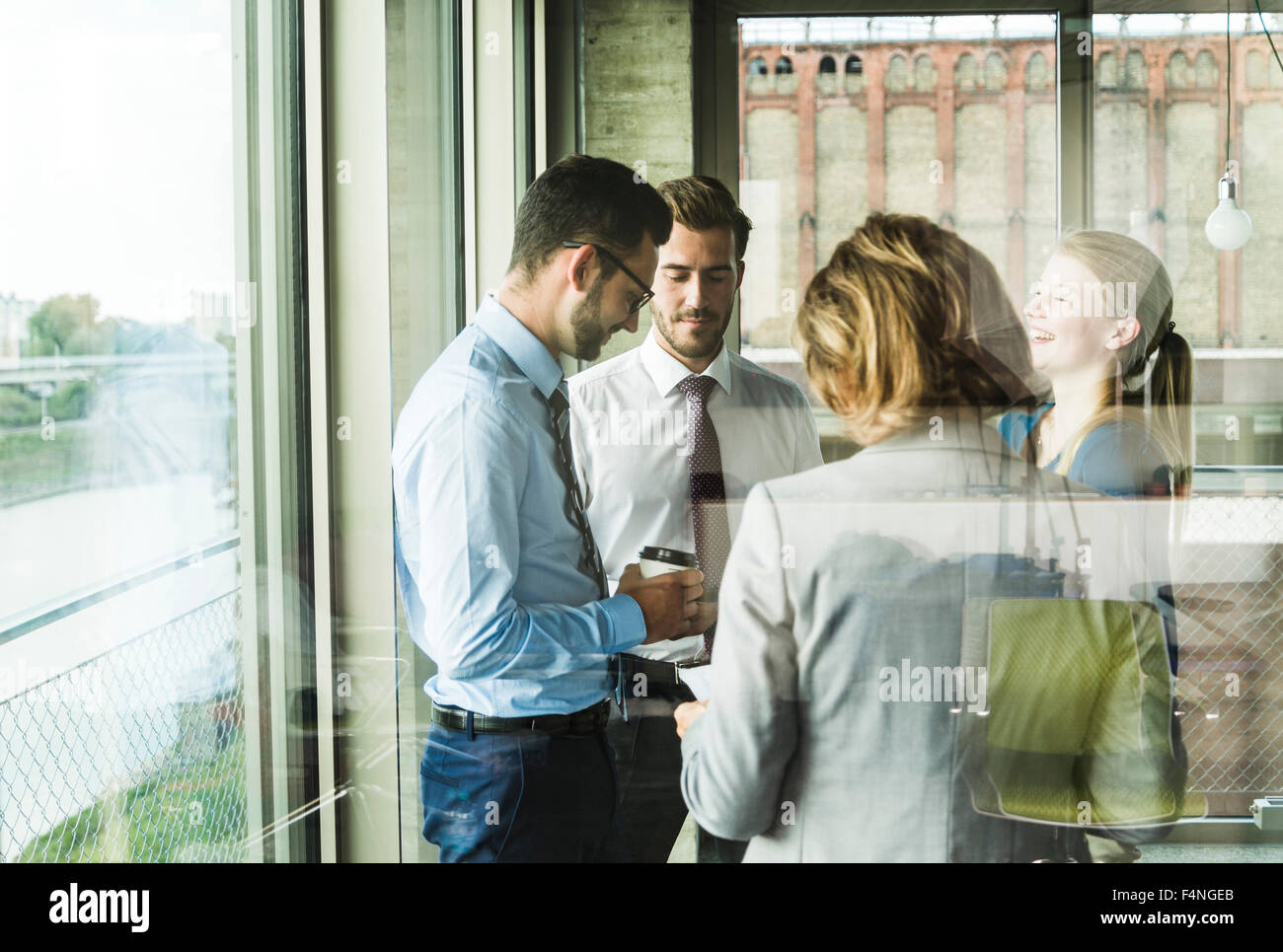 Business people talking at the window Stock Photo - Alamy