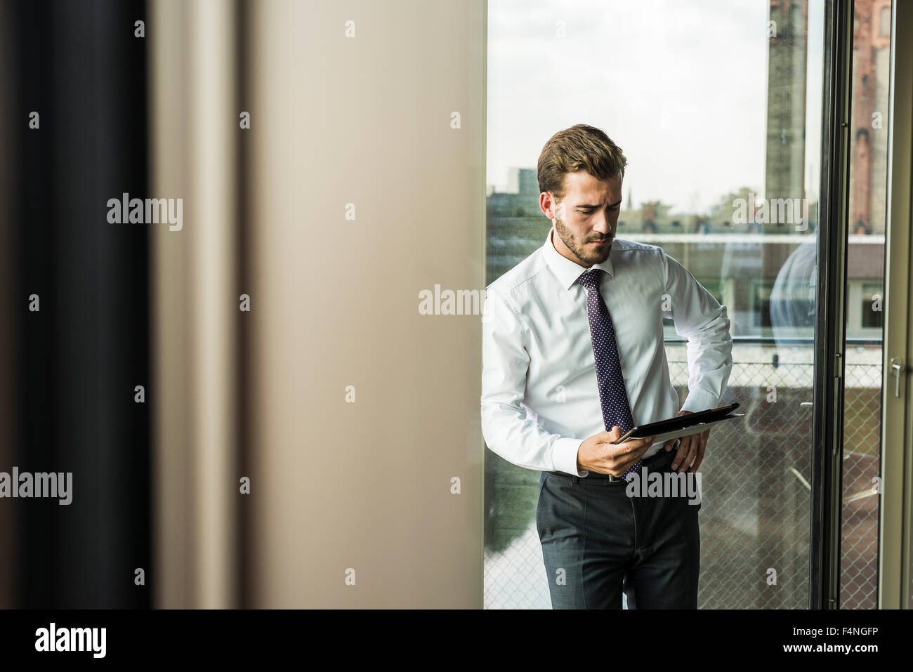Young businessman looking at digital tablet Stock Photo