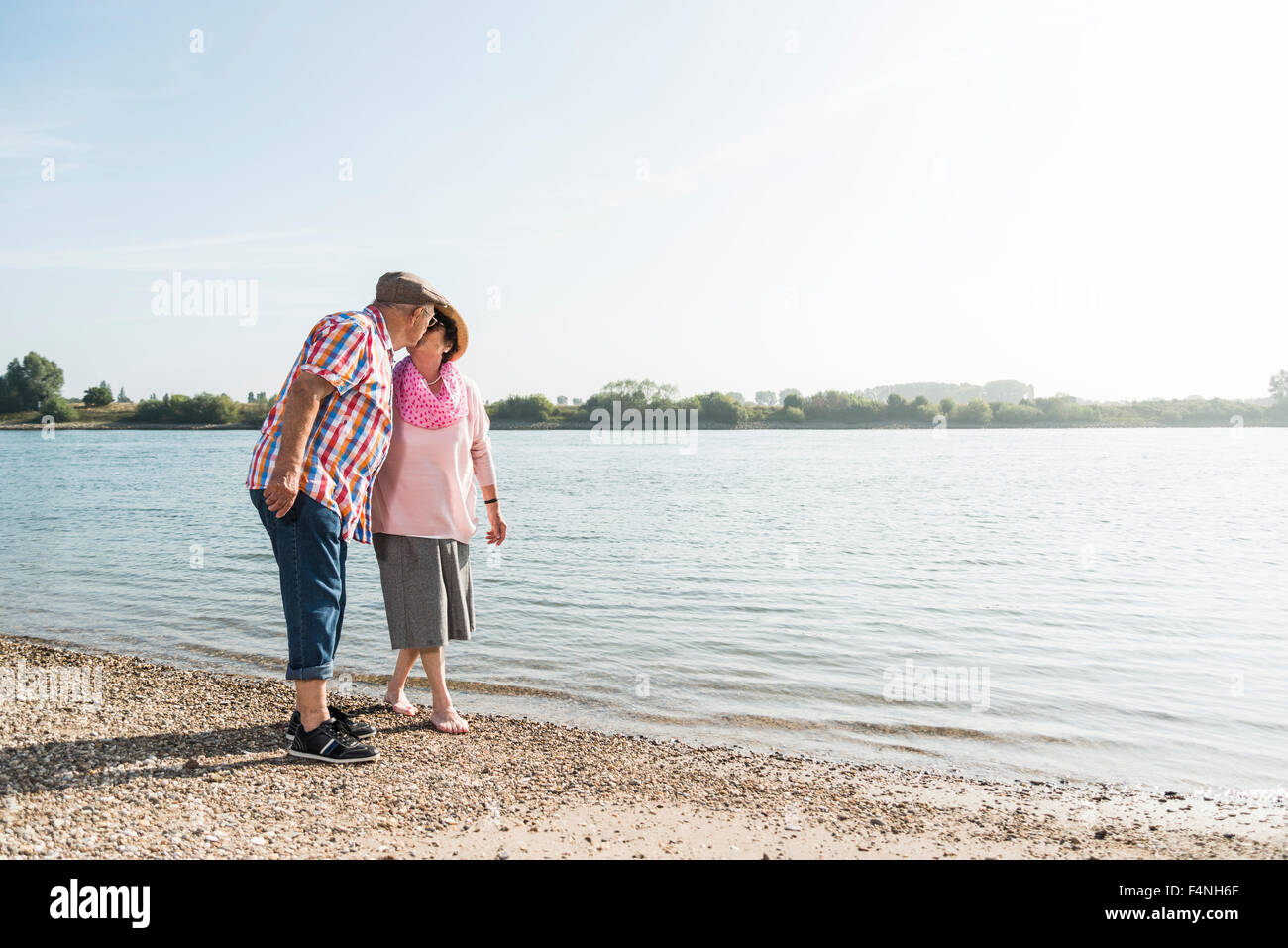 Kissing senior couple at riverside Stock Photo - Alamy