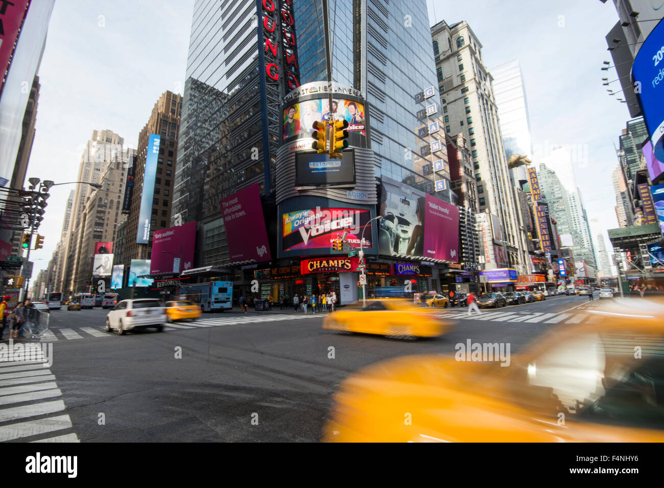 Taxi cabs driving along 7th Avenue as it crosses 42nd St in Times Square, Midtown Manhattan New York USA Stock Photo