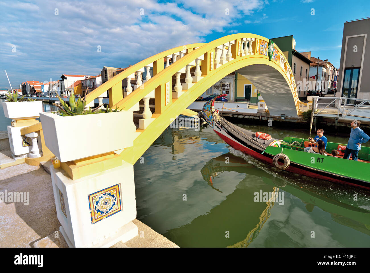 Portugal, Aveiro: Traditional Moliceiro boat with tourists passing bridge of Sao Roque Channel Stock Photo