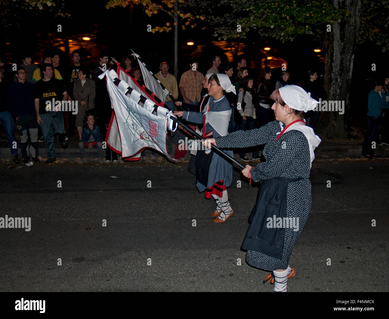 Local Basque people marching through their town in traditional Basque dress in Oñati during tamborrada. Basque Country. Spain. Stock Photo