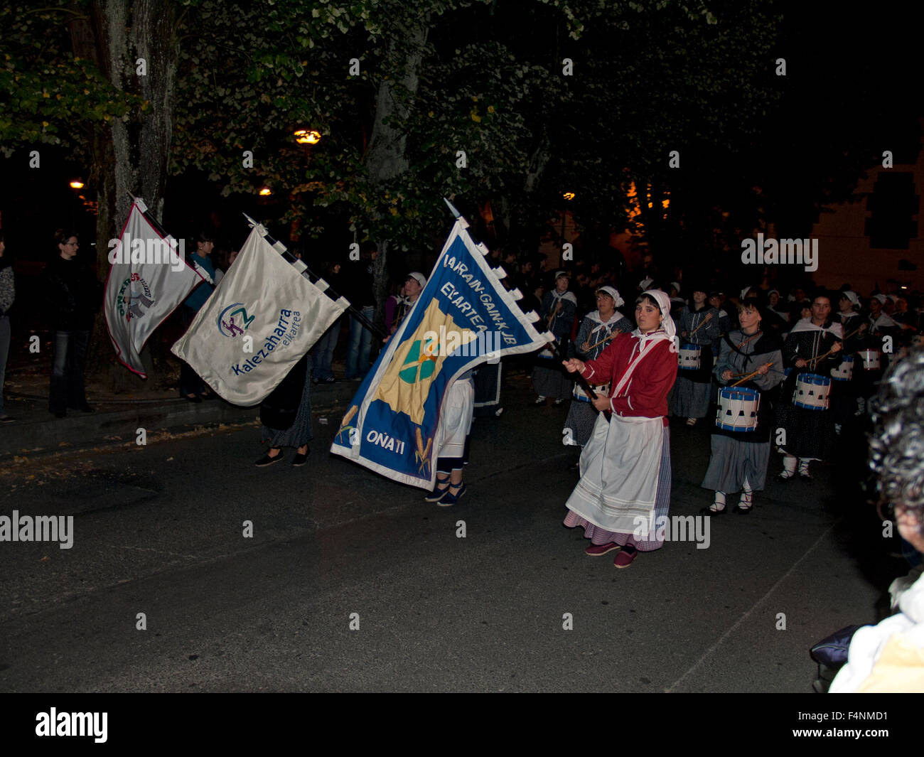 Local Basque people marching through their town in traditional Basque dress in Oñati during tamborrada. Basque Country. Spain. Stock Photo