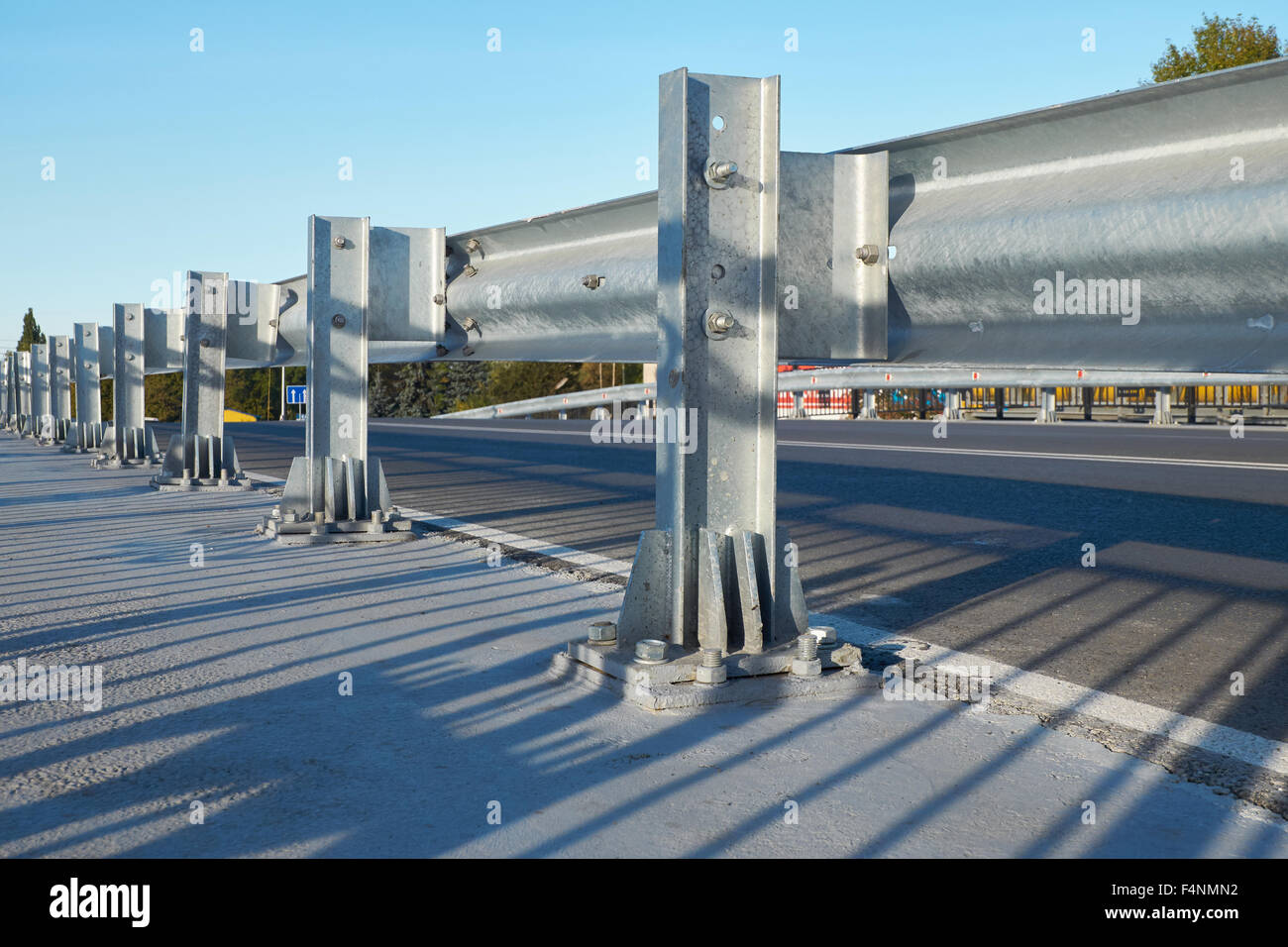 Anodized safety steel barrier on freeway bridge Stock Photo