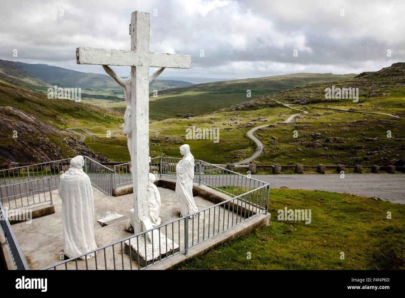 Catholic iconography remains common in parts of rural Ireland. This crucifixion scene overlooks the narrow winding Healy Pass between Cork and Kerry Stock Photo