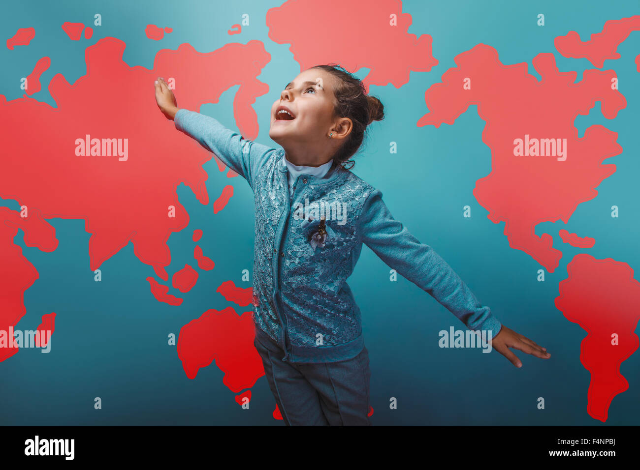 girl teen her arms flying  behind world map education background Stock Photo