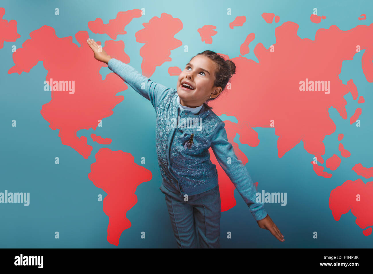 teen girl her arms flying  behind world map education background Stock Photo