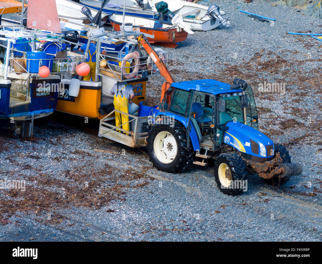 New Holland Tractor on Cadgwith Beach, Lizard Peninsula, Cornwall, England, UK Stock Photo