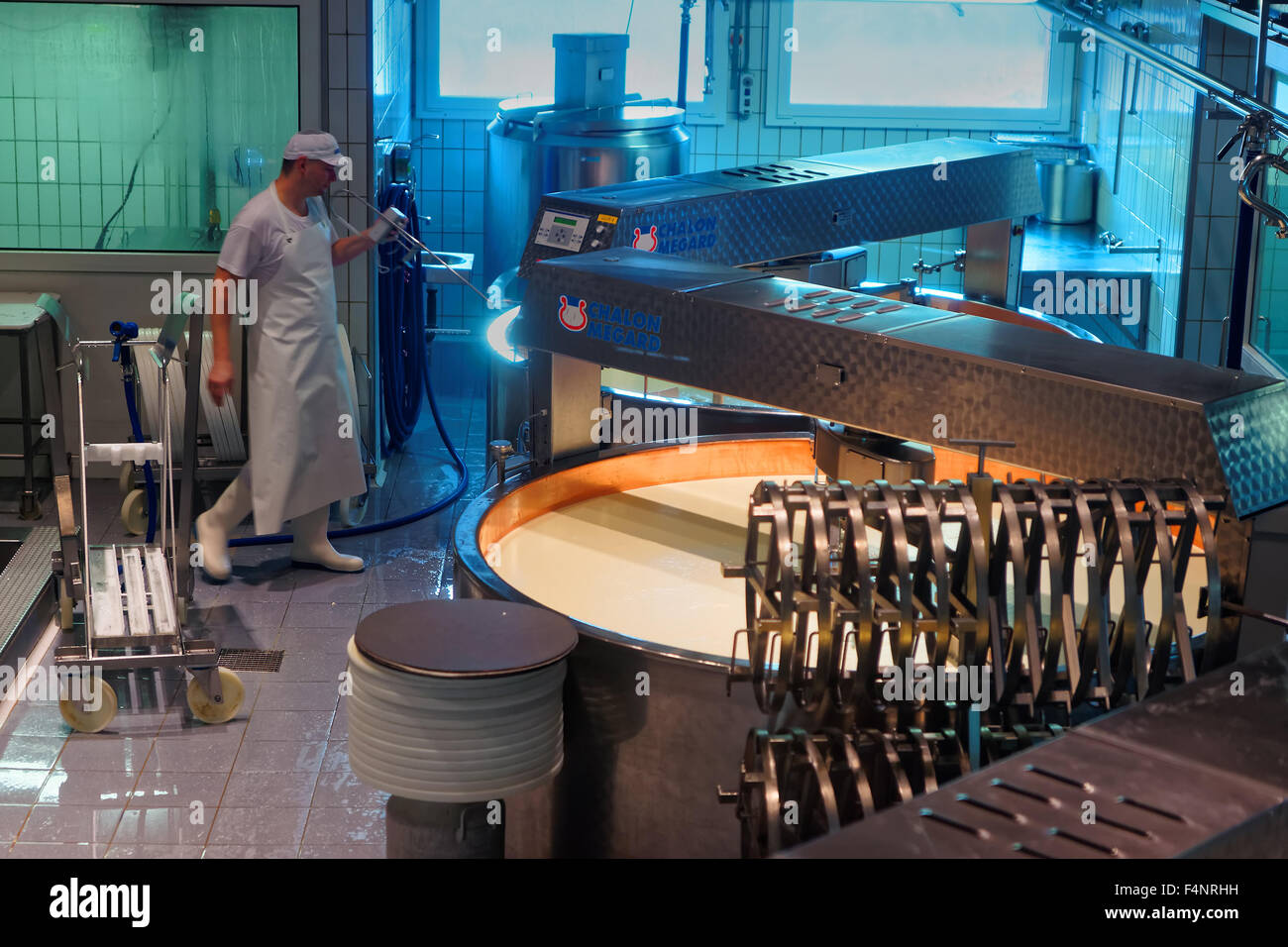 GRUYERE, SWITZERLAND DECEMBER 31, 2014 Cheesemaker is at work during the processing of the