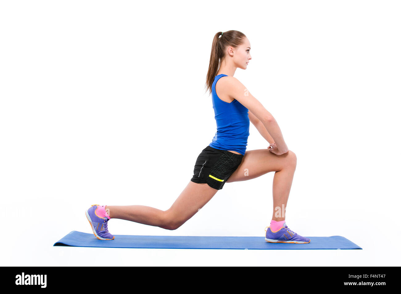Portrait Of A Sports Woman Doing Warm Up Exercises On Yoga Mat