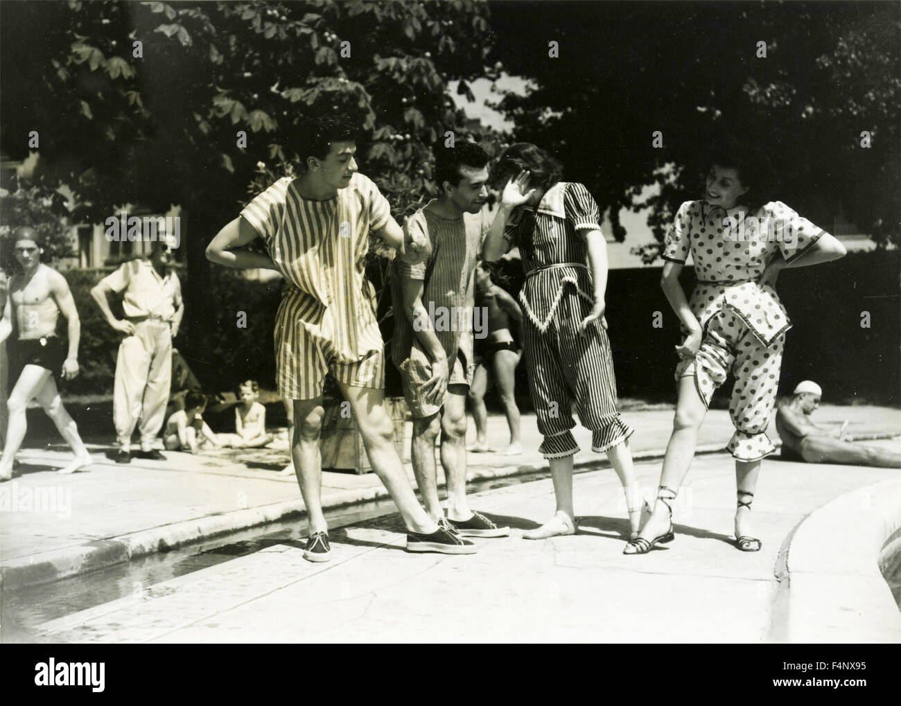 Two pairs of young people with funny clothes on the bank of a pool Stock Photo - Alamy Two pairs of young people with funny clothes on the bank of a pool Stock Photo - Alamy