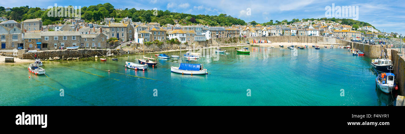 A 4 picture stitch panoramic view of the harbour at the fishing port and village of Mousehole in Cornwall. Stock Photo