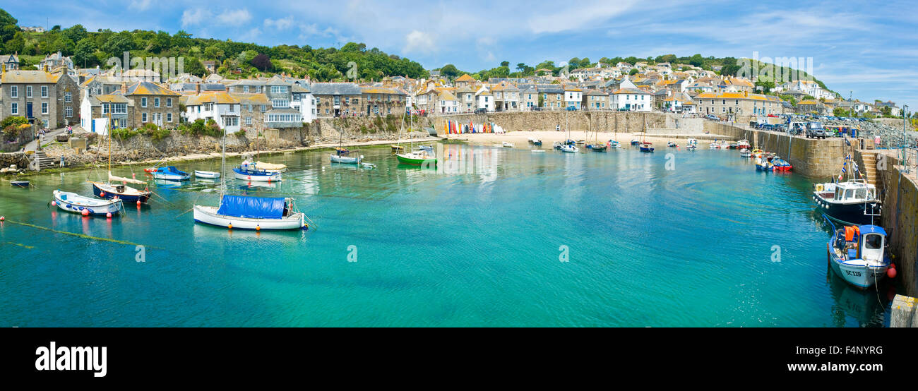 A 3 picture stitch panoramic view of the harbour at the fishing port and village of Mousehole in Cornwall. Stock Photo