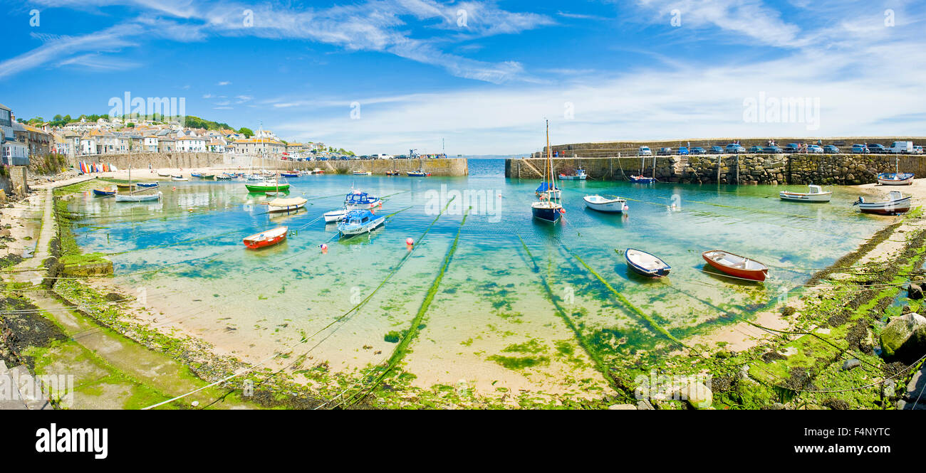 A 2 picture stitch panoramic view of the harbour at the fishing port and village of Mousehole in Cornwall. Stock Photo
