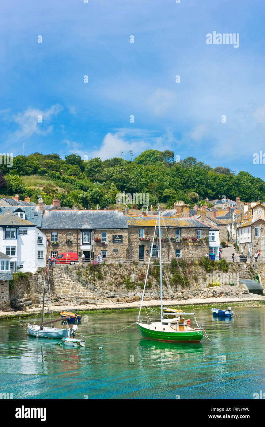 A view of the harbour in the quaint and picturesque fishing port and village of Mousehole in Cornwall. Stock Photo