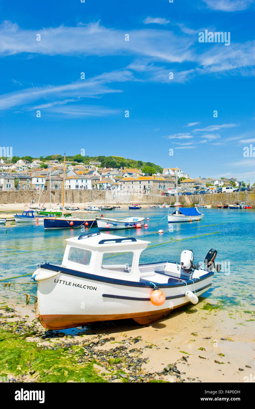 A view of the harbour in the quaint and picturesque fishing port and village of Mousehole in Cornwall. Stock Photo