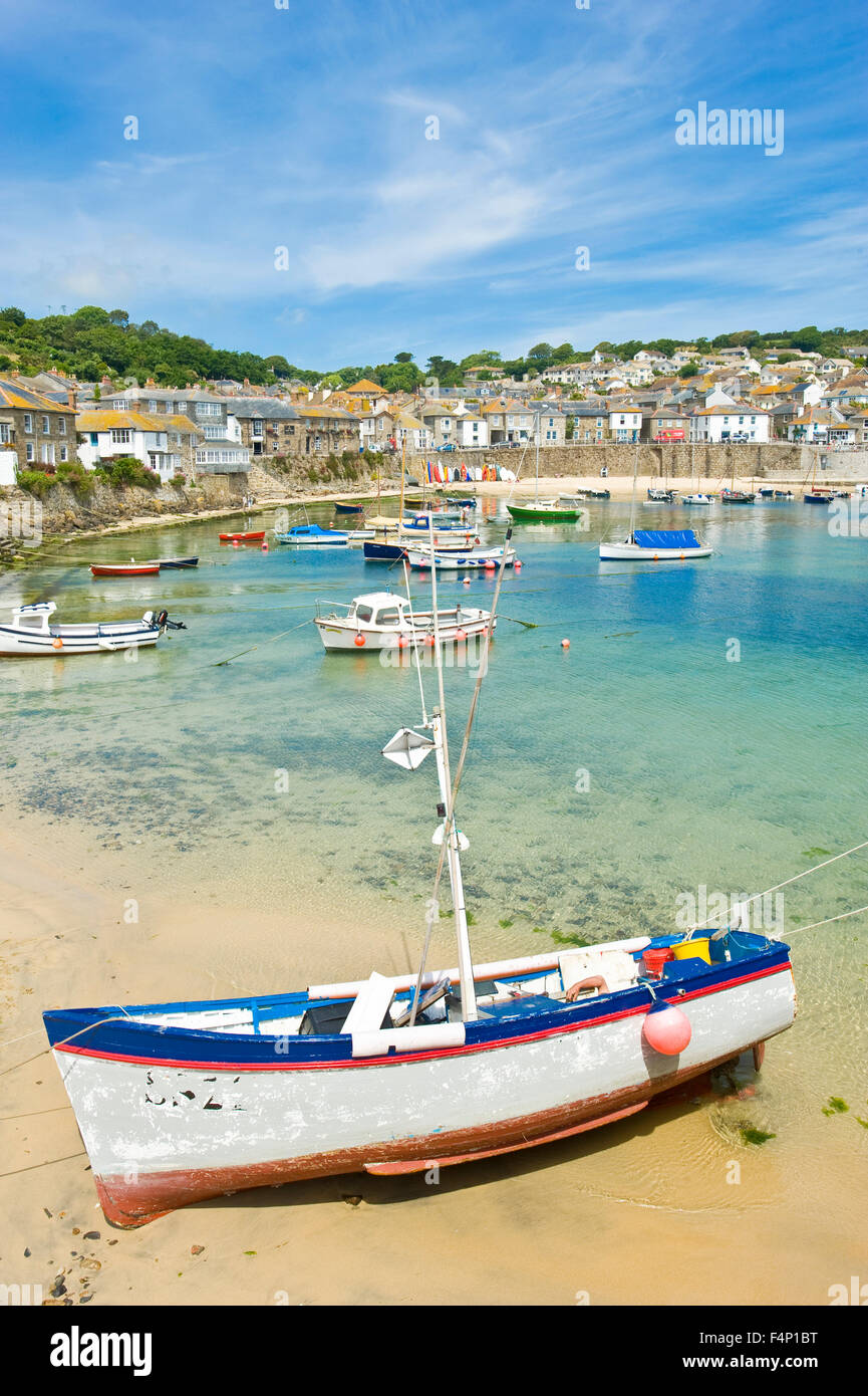 A view of the harbour in the quaint and picturesque fishing port and village of Mousehole in Cornwall. Stock Photo