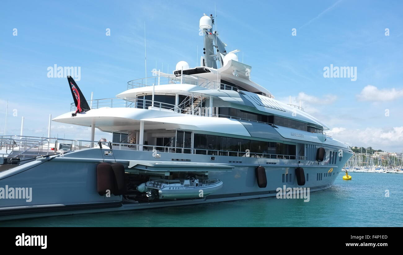 Luxury yacht in dock at Antibes France.  A dinghy is launched from the yacht. Stock Photo