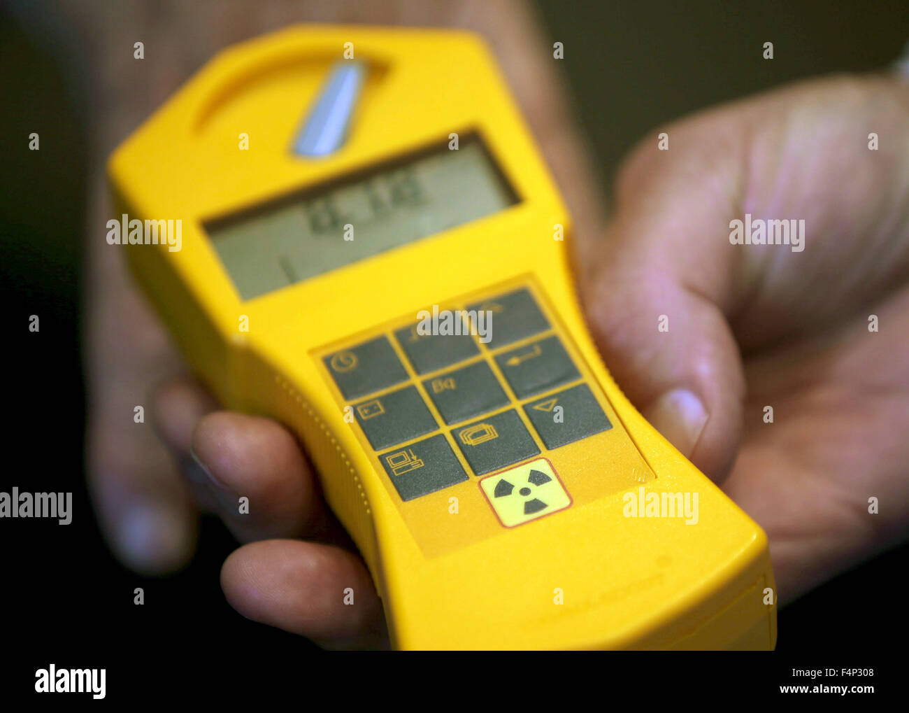 A doctor from the federation 'International Physicians for the Prevention of Nuclear War' holds a dosimeter for the measurement of radioactive rays in front of the council hall at city hall in Aachen, Germany, 21 October 2015. Physicians are demanding the general provision of iodine tablets to the population of Aachen before a nuclear accident. The oldest Belgian nuclear power plant, Tihange, is only 60 kilometers away. A reactor block is not in service due to thousands of tiny cracks. Another has been turned off for repairs. Photo: OLIVER BERG/dpa Stock Photo