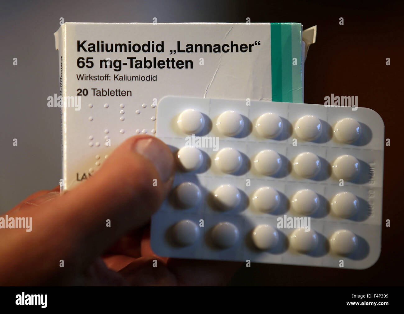 A doctor from the federation 'International Physicians for the Prevention of Nuclear War' holds iodine tablets in front of the council hall at city hall in Aachen, Germany, 21 October 2015. Physicians are demanding the general provision of iodine tablets to the population of Aachen before a nuclear accident. The oldest Belgian nuclear power plant, Tihange, is only 60 kilometers away. A reactor block is not in service due to thousands of tiny cracks. Another has been turned off for repairs. Photo: OLIVER BERG/dpa Stock Photo