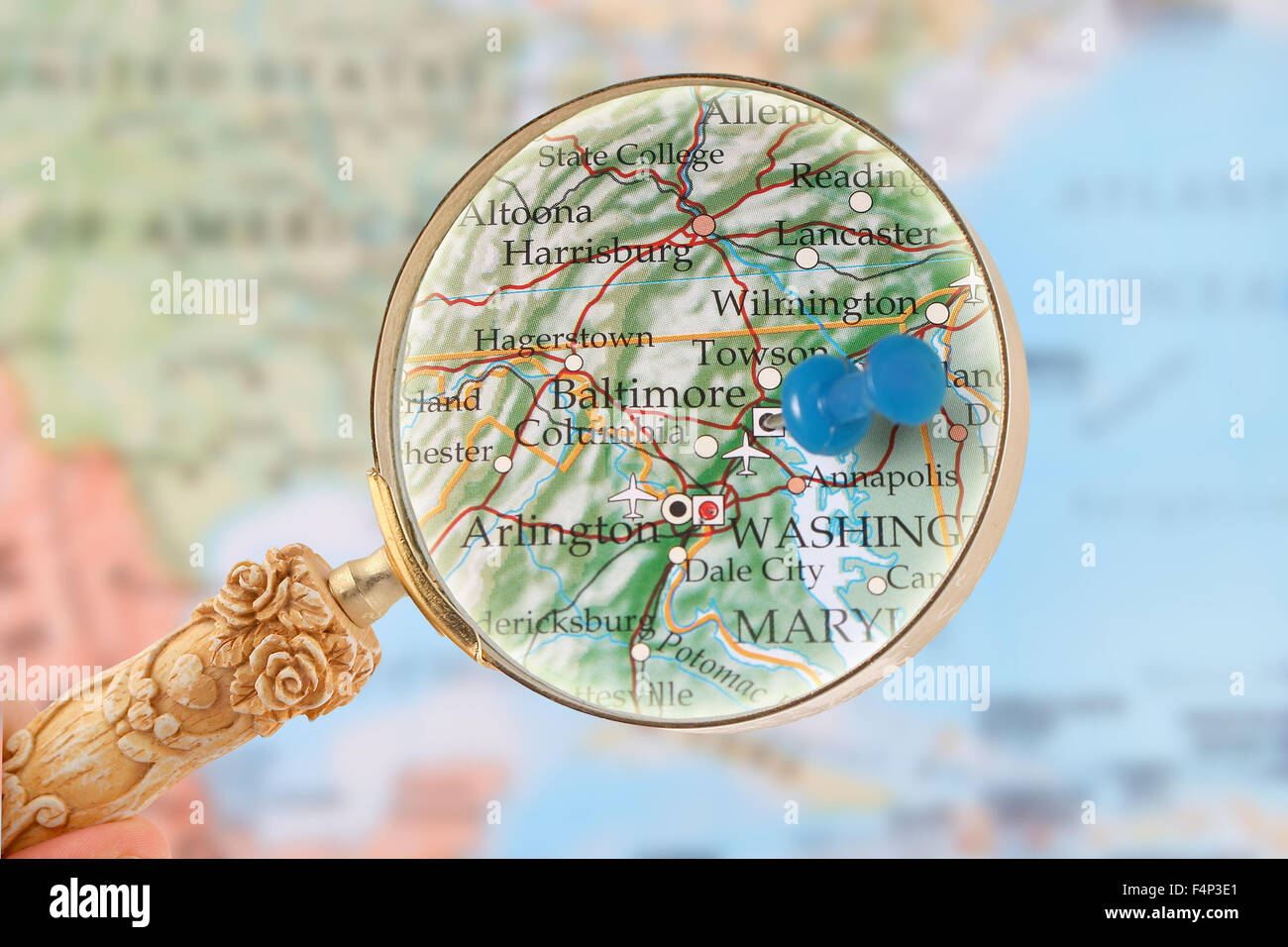 Looking in on Baltimore, Maryland, USA through a magnifying glass with blurred map in the background Stock Photo