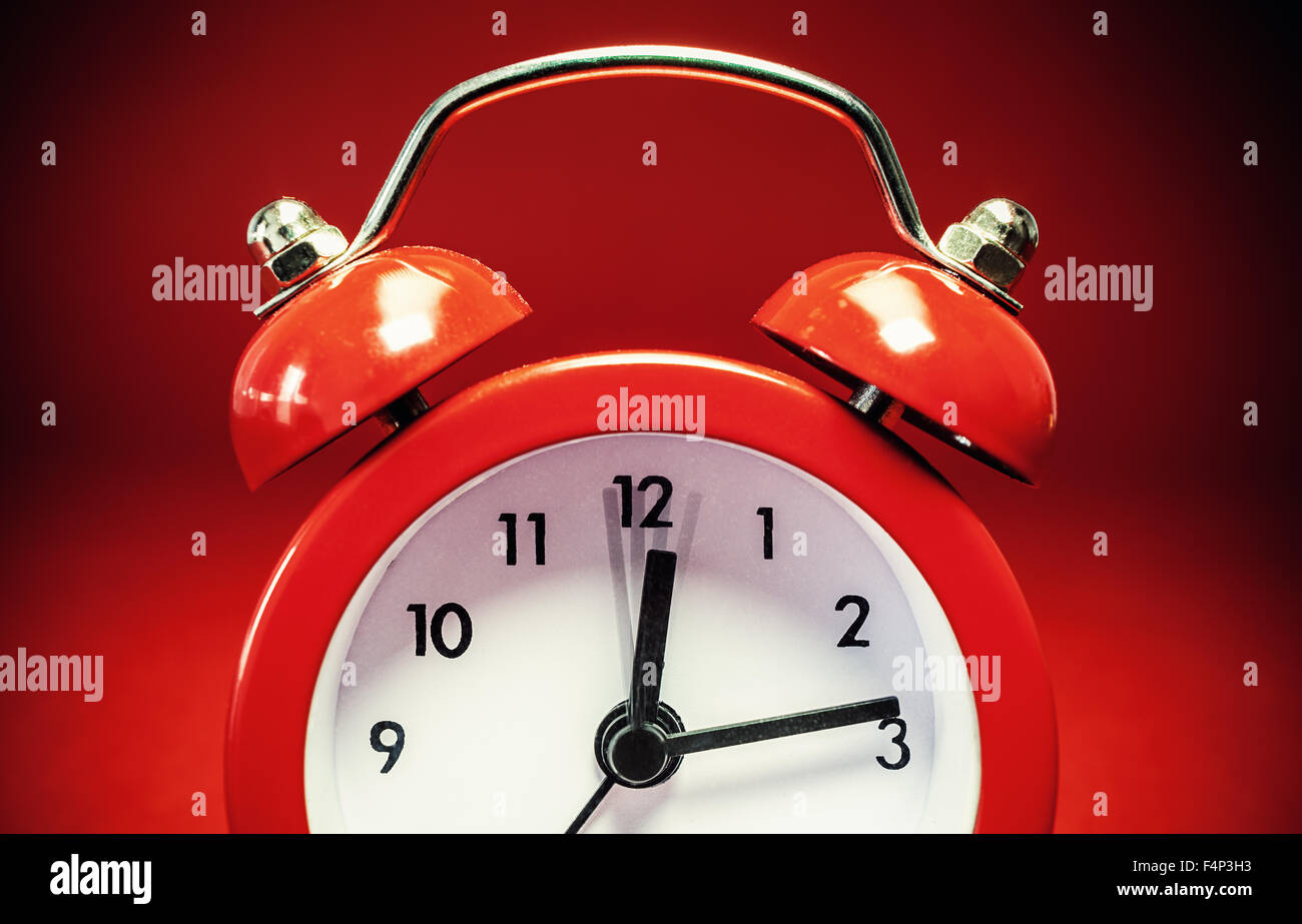 Details of an old red watch on red background. Stock Photo