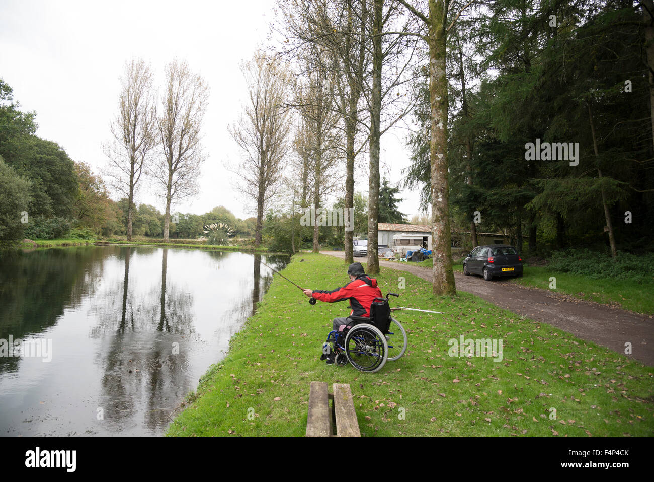 A stroke survivor fly fishing from a wheelchair Stock Photo