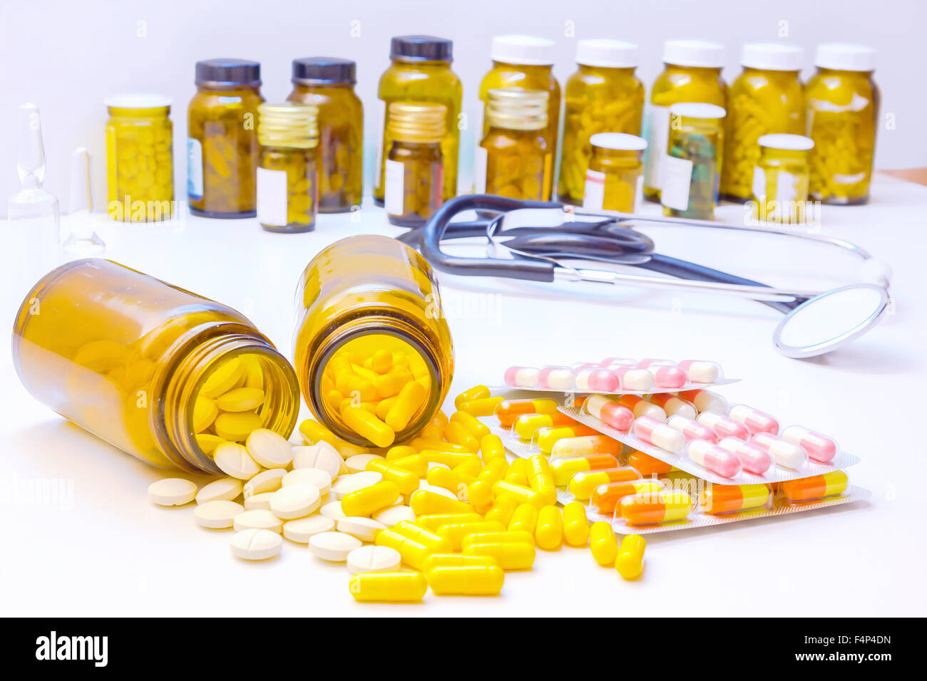 Various Tablets and Pills in a Glass Bottle Stock Photo