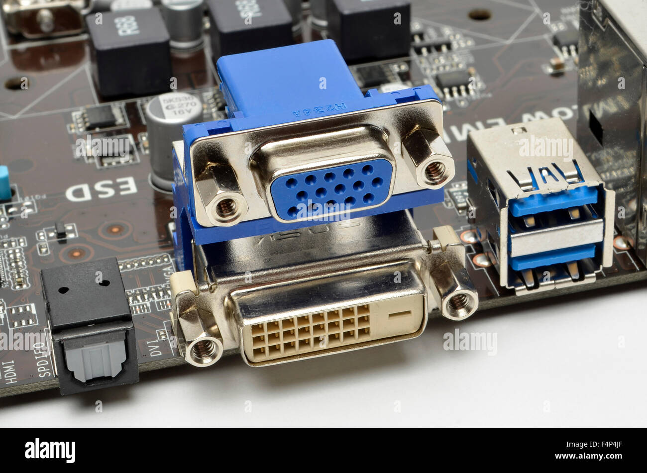 I/O ports on the rear of an ASUS motherboard, including left to right S/PDIF, VGA, DVI-D, and twin USB 3.0 sockets. Stock Photo