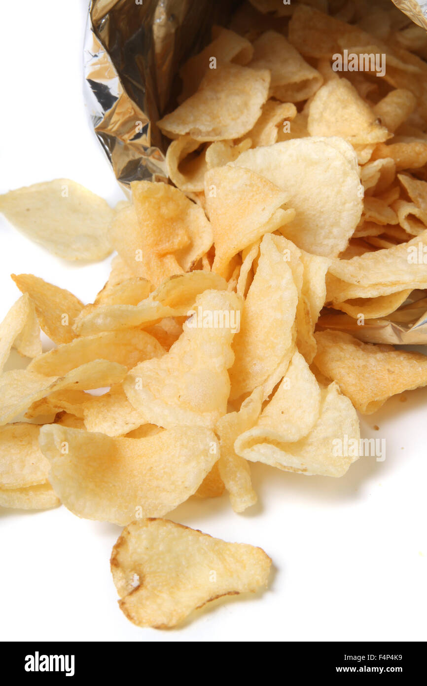 Bag of kettle chips spilling over on a white background Stock Photo Alamy